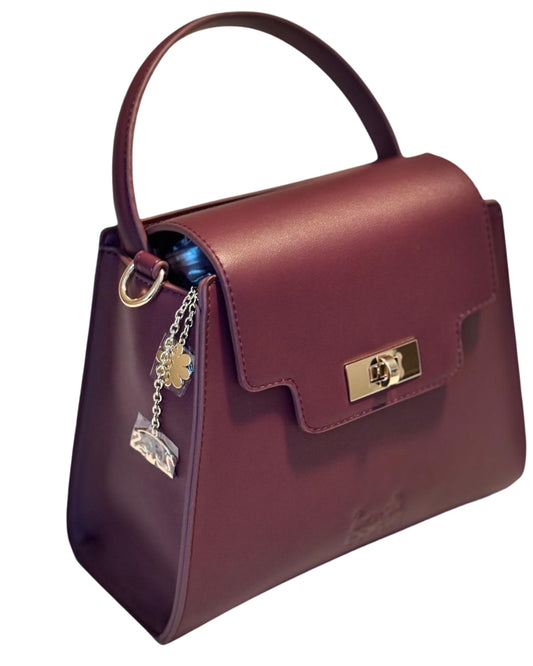Burgundy Tundra CSWAN handbag angled view showing structured shape, top handle, and gold clasp