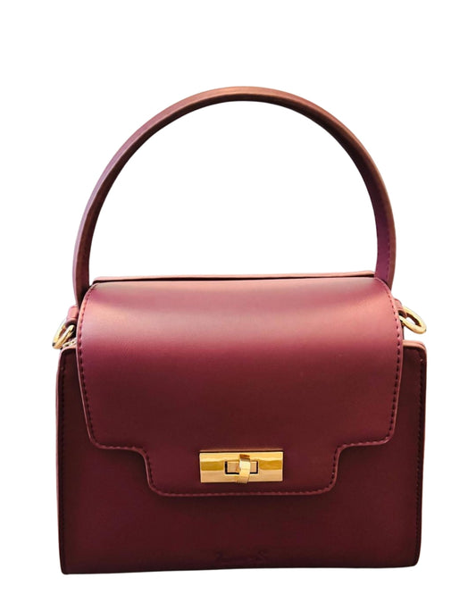 Front view of Burgundy Tundra – CSWAN featuring structured silhouette, top handle, embossed logo, and gold-tone turn-lock closure