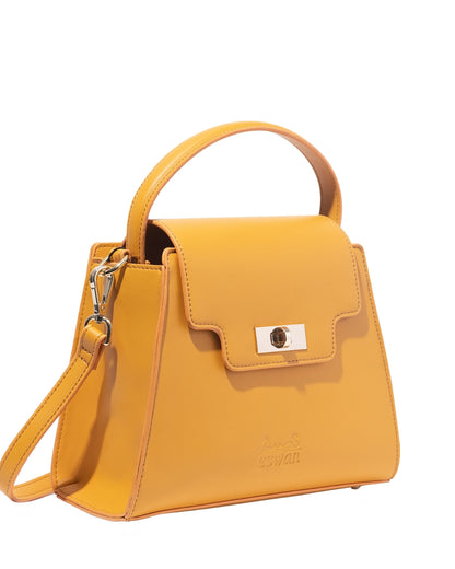 Camel Tundra – CSWAN handbag angled view showing structure, top handle, and gold clasp