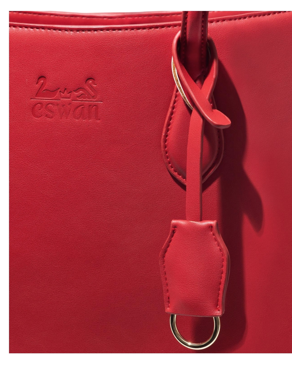 Close-up of Scarlet Trumpeter – CSWAN featuring embossed logo, gold-tone ring hardware, and refined leather craftsmanship detailing